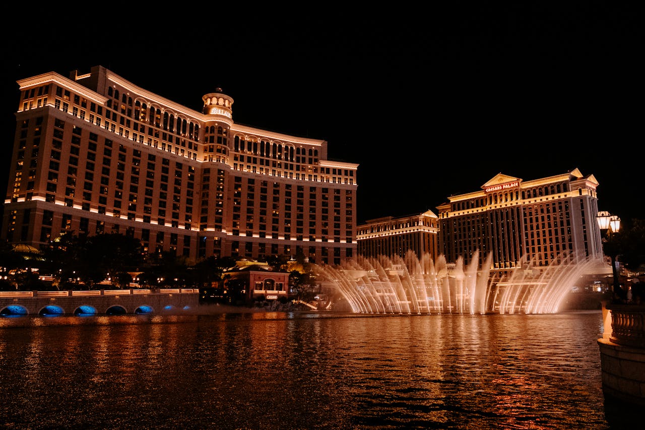 A stunning view of the Bellagio Hotel and fountains illuminated at night in Las Vegas, NV.